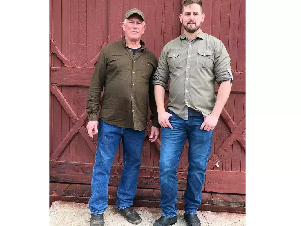 Fred and Jamie Peterson in front of a red barn door